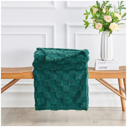 Cozy Bentley Jacquard Throw folded neatly on armchair in living room