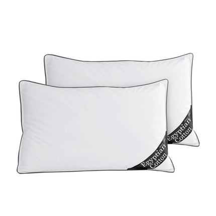 These luxurious white Egyptian cotton pillows feature elegant black piping along the edges, adding a refined touch to their design. The premium Egyptian cotton ensures exceptional softness and breathability, offering a plush and comfortable sleeping experience. Each pillow is adorned with a black corner tag denoting its high-quality material, reinforcing its status as a sophisticated and durable bedding essential. Perfect for enhancing relaxation, these pillows seamlessly blend style, comfort,