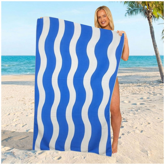 Ocean blue wavy stripe microfiber towel with a modern look, designed for travel, swimming, and sunny beach days.