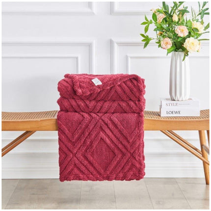 Lifestyle shot of Charmane Jacquard Throw layered with cushions on sofa