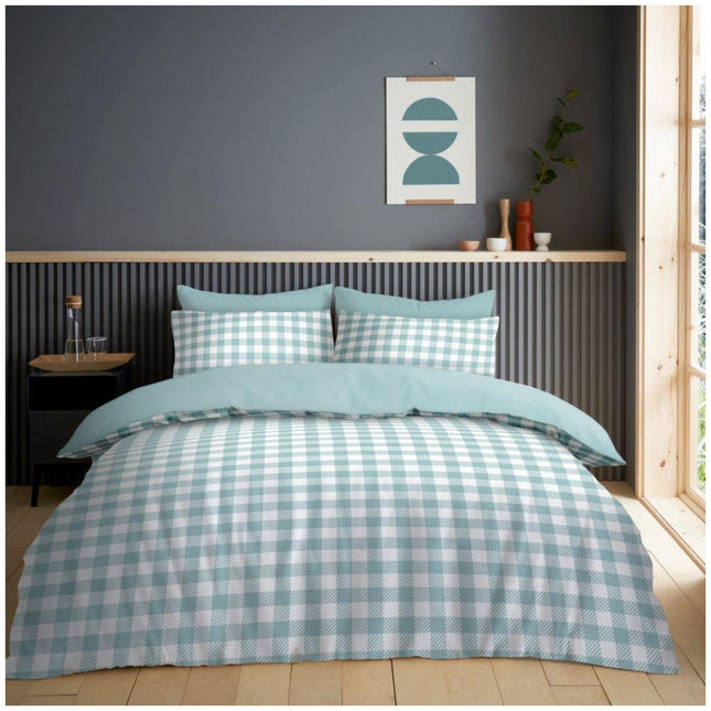 Create a peaceful retreat in your bedroom with this beautifully designed minimalist bedding set. The duvet cover showcases a soft checkered pattern in light blue and white, adding texture and freshness without overwhelming the space. The upper portion of the cover and the reverse side of the pillowcases feature a solid light blue tone, introducing a gentle contrast that enhances the overall look. Neatly tailored edges and a crisp finish complete the ensemble,