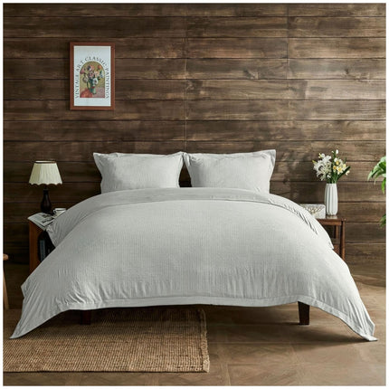 Light grey duvet cover set with subtle seersucker detailing and a soft, modern aesthetic for relaxing interiors.