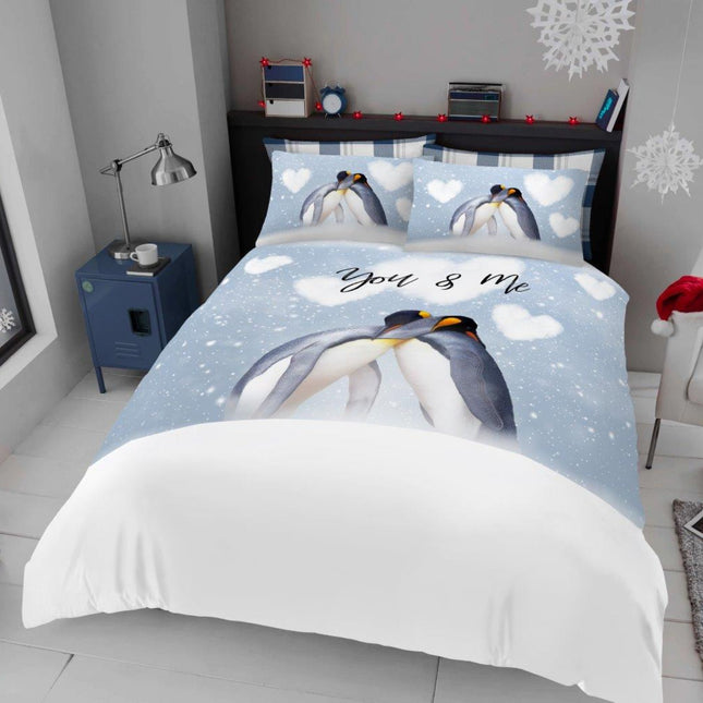 This charming duvet cover set features an adorable design of two penguins cuddling under a snowy sky with heart-shaped clouds and the sweet phrase "You & Me," creating a cozy and romantic atmosphere for any bedroom. Made from soft, high-quality materials, it offers comfort and warmth while adding a touch of playful elegance. Perfect for penguin lovers or anyone looking to brighten their sleep space with a cute, winter-inspired theme, this set includes matching pillowcases to complete the look. 