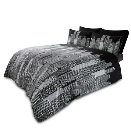 Modern black and white reversible duvet cover set featuring a striking city skyline print, displayed on a neatly made bed with matching pillowcases. Ideal for urban-themed or contemporary bedroom décor.