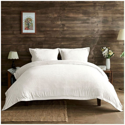 White Signature Newry duvet cover set with a delicate seersucker pattern and a fresh, elegant bedroom appearance.