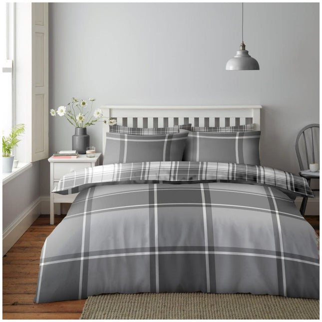 Bring timeless style to your bedroom with this Reversible Check Pattern Duvet Cover Set in Grey, featuring a bold, modern plaid design on one side and a sleek, contrasting pattern on the reverse. Crafted from soft, breathable microfiber, this bedding set offers everyday comfort with easy maintenance. The neutral grey tones blend effortlessly with any interior, making it a perfect choice for both contemporary and classic spaces. Includes matching pillowcases and is available in Single, Double, and King size