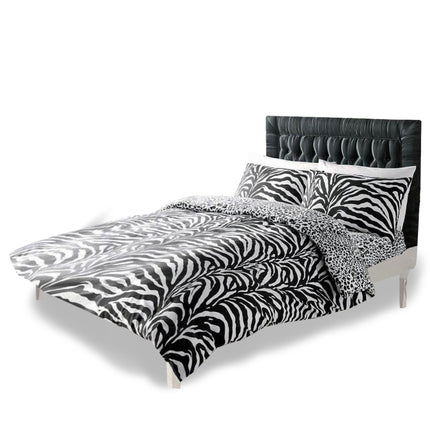 Transform your bedroom into a chic safari retreat with this bold Zebra Print Reversible Duvet Cover Set, featuring striking black and white zebra stripes on one side and a contrasting leopard print on the reverse for versatile style options. Crafted from soft, breathable polycotton, this set offers both comfort and durability, making it perfect for everyday use. Complete with matching pillowcases, it adds a dramatic, animal-inspired touch to any modern or eclectic bedroom decor.