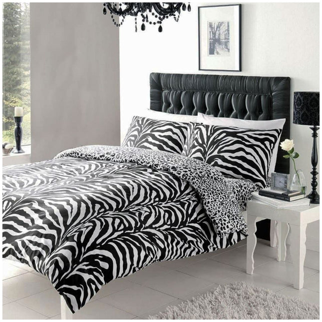 Elevate your bedroom decor with this eye-catching Zebra Print Reversible Duvet Cover Set, designed to bring wild elegance and modern flair to your space. Featuring a bold zebra stripe pattern on one side and a stylish leopard print on the other, this polycotton bedding combines comfort and style effortlessly. Soft, durable, and easy to care for, it includes matching pillowcases for a coordinated look that makes a statement.